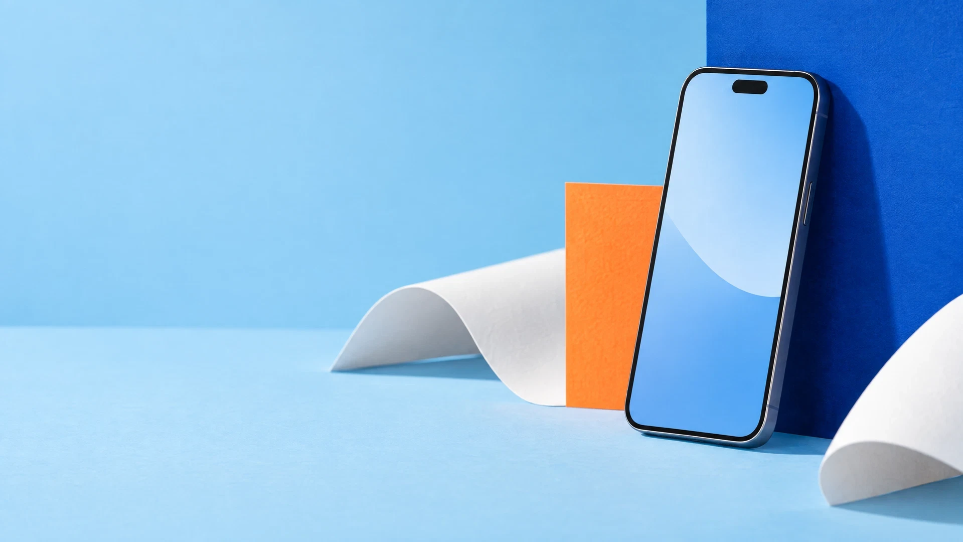 Unbranded smartphone prototype against blue studio panel with orange card